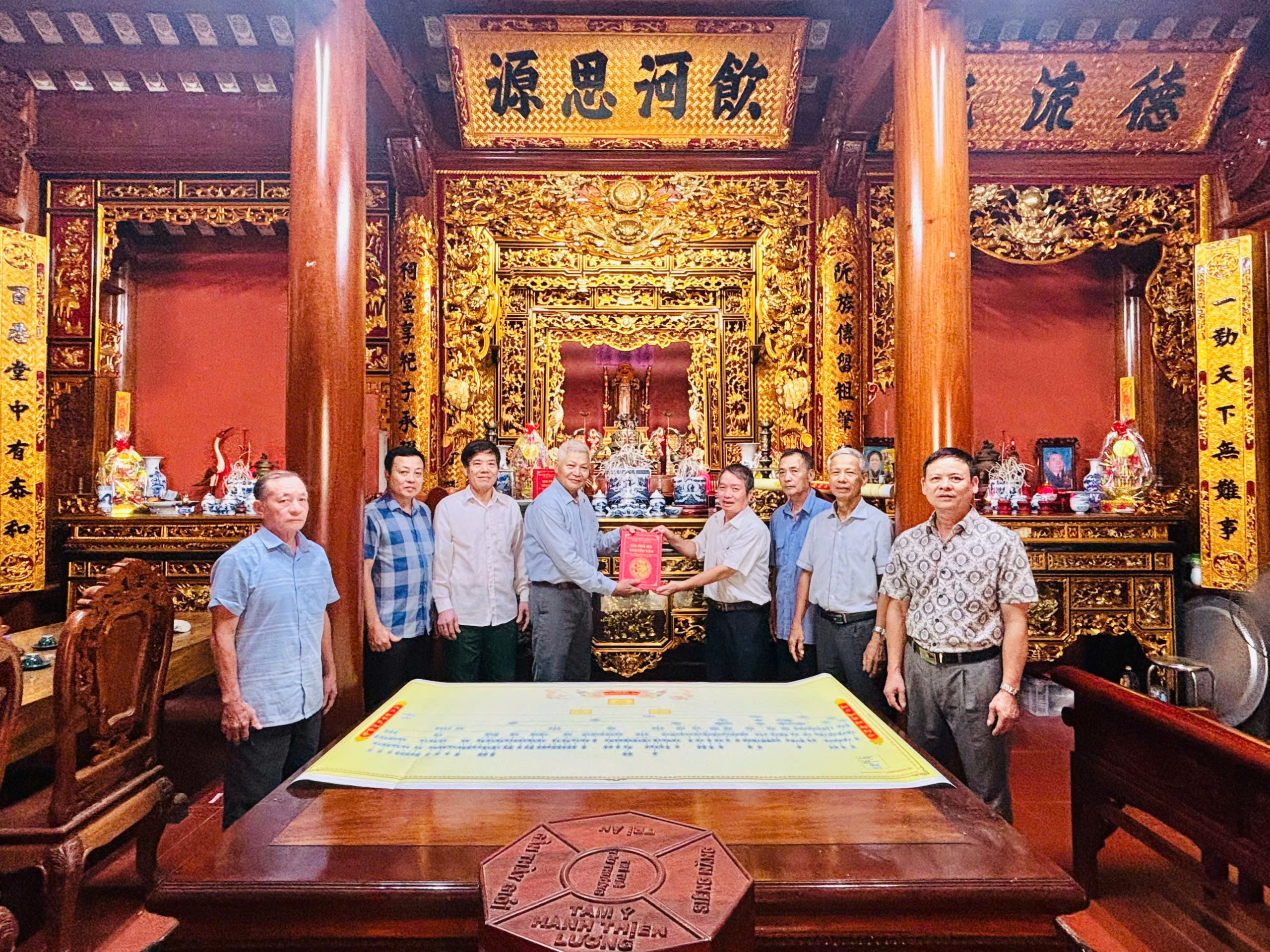 A group of men standing in front of a large table AI-generated content may be incorrect.